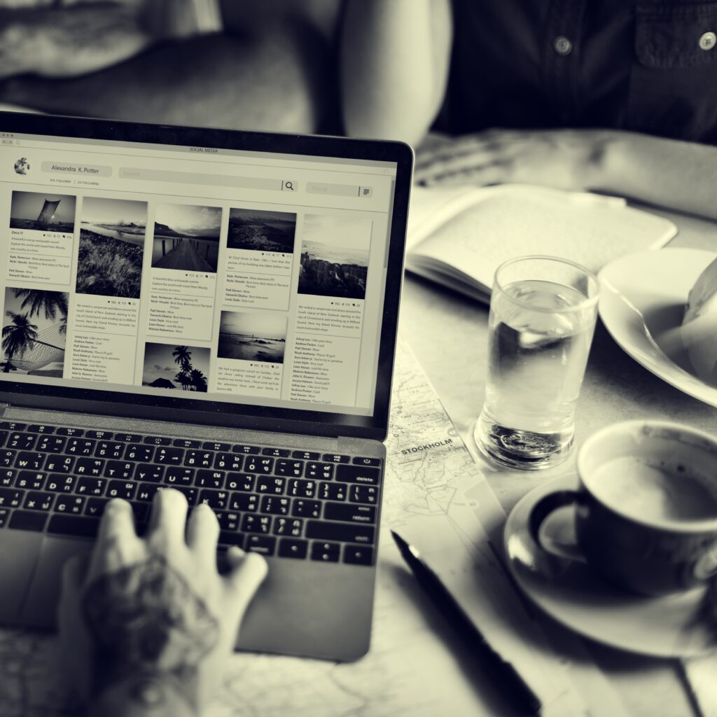 laptop open on table with coffee mug and pen